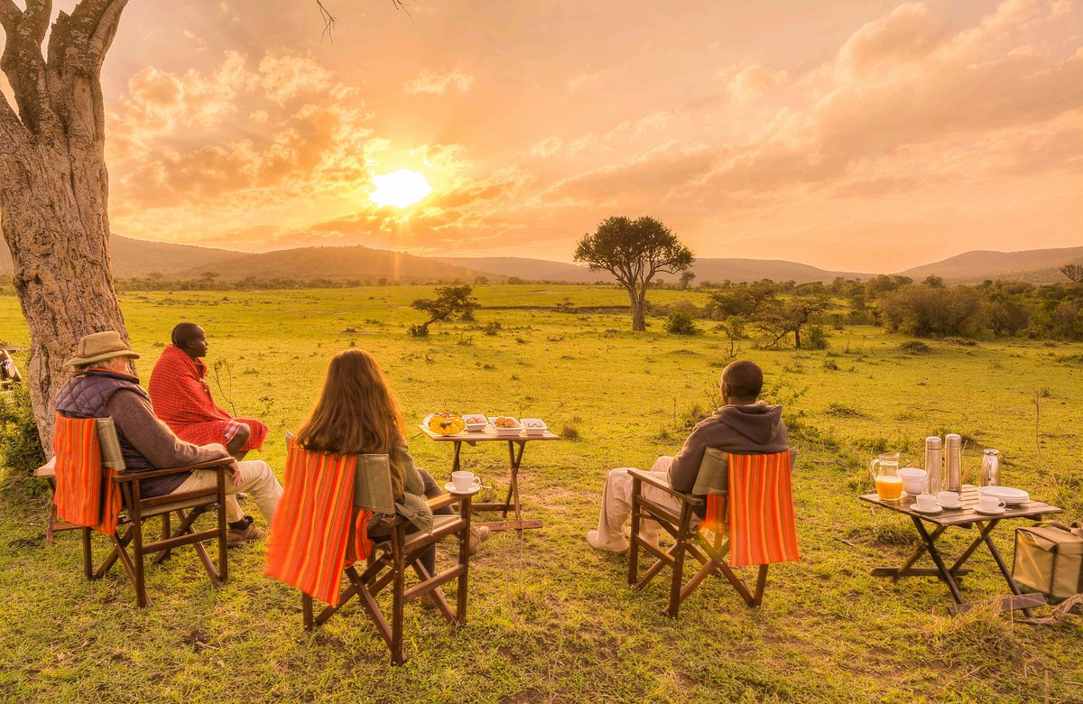 Couple enjoying a sundowner in the savannah